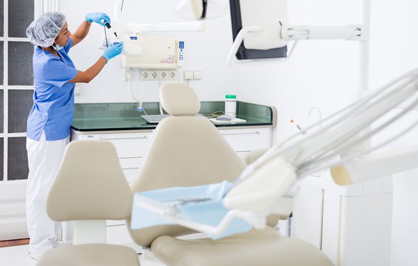 Dentist preparing dental workplace